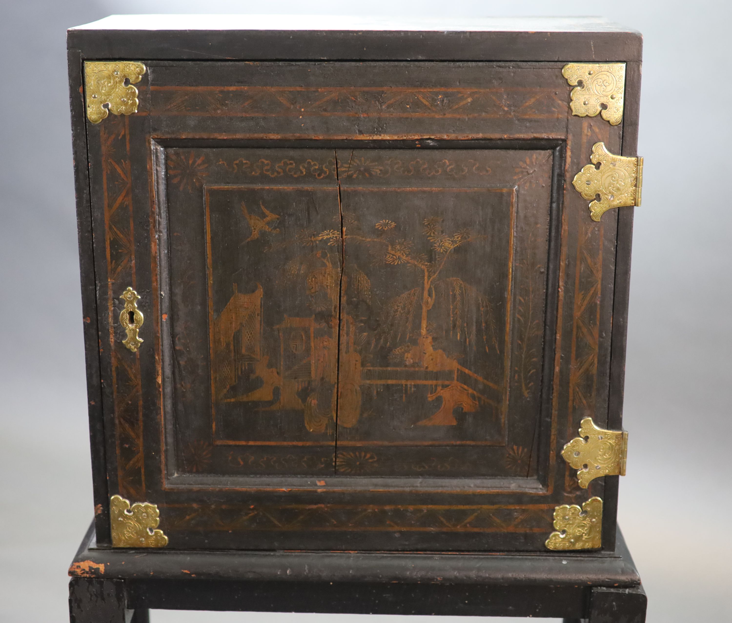 An early 18th century European japanned cabinet on stand, W.54cm D.24cm H.115.5cm